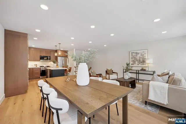 a kitchen with a table chairs and a refrigerator