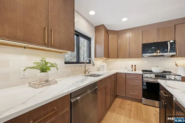 a kitchen with a sink a stove and cabinets