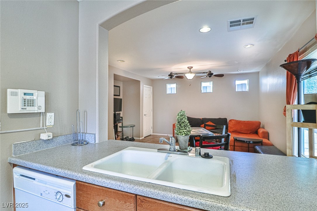 9068 West Alluring Avenue Las Vegas, NV 89149 - Photo 48 of 48 Kitchen with dishwasher, arched walkways, light countertops, recessed lighting, and open floor plan