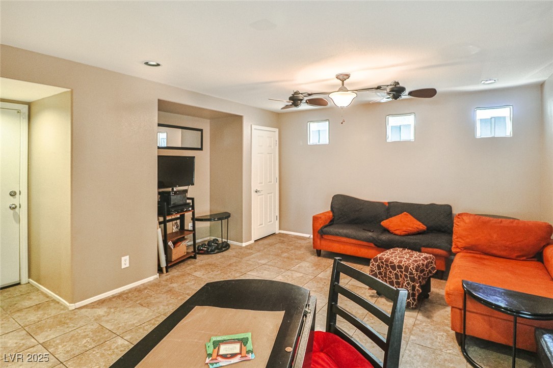 9068 West Alluring Avenue Las Vegas, NV 89149 - Photo 14 of 48 Living area with light tile patterned floors, plenty of natural light, a ceiling fan, and recessed lighting