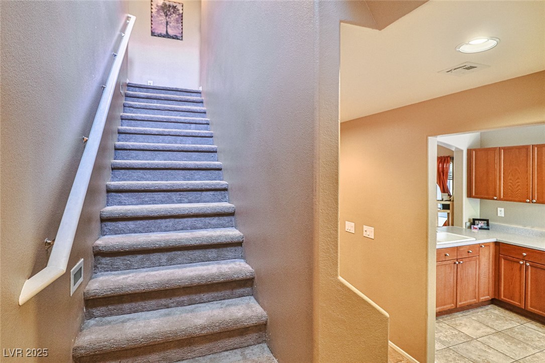 9068 West Alluring Avenue Las Vegas, NV 89149 - Photo 19 of 48 Staircase with a textured wall and tile patterned floors