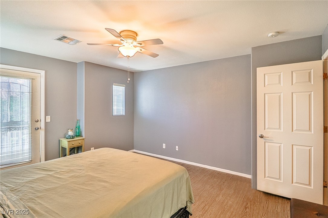 9068 West Alluring Avenue Las Vegas, NV 89149 - Photo 22 of 48 Bedroom featuring light wood-type flooring and a ceiling fan