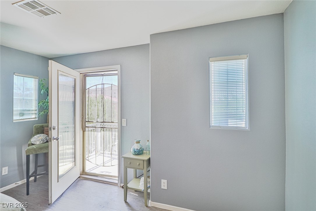9068 West Alluring Avenue Las Vegas, NV 89149 - Photo 28 of 48 Entrance foyer featuring healthy amount of natural light, wood finished floors, and french doors