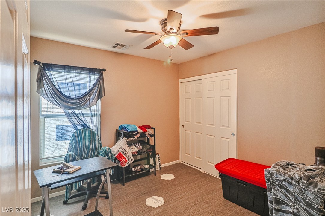 9068 West Alluring Avenue Las Vegas, NV 89149 - Photo 32 of 48 Bedroom featuring wood finished floors, a closet, and ceiling fan