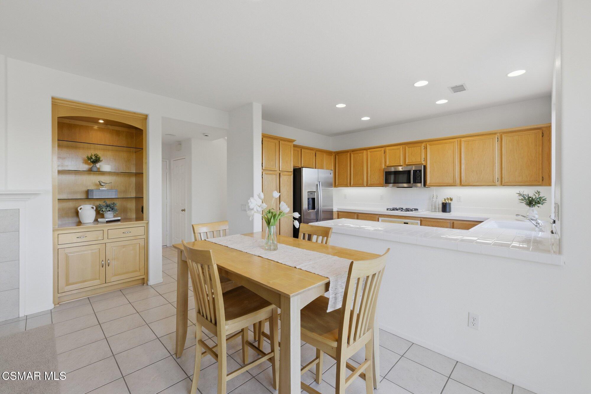3205 Pine View Drive Simi Valley, CA 93065 - Photo 15 of 72 a kitchen with stainless steel appliances kitchen island granite countertop a sink and cabinets