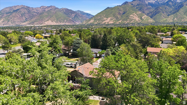 8938 Manchester Lane Sandy, UT 84093 - Photo 45 of 50 Expansive mountain backdrop framing a verdant neighborhood with mature trees