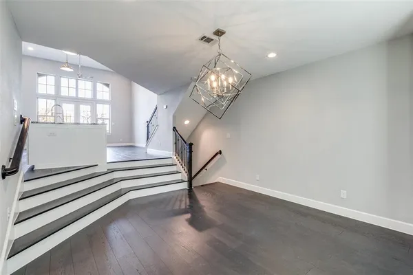 a view of a dining room with furniture wooden floor and chandelier