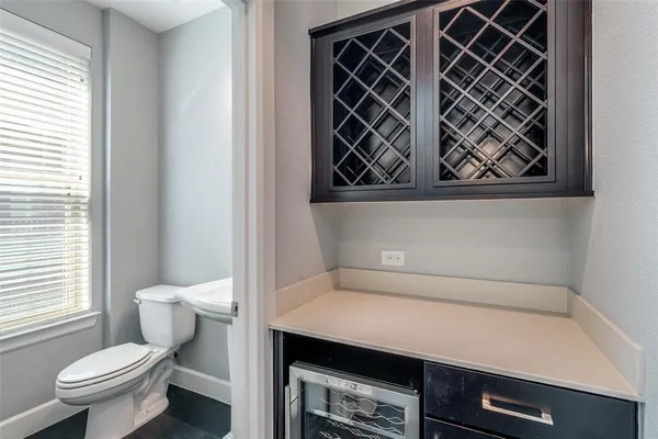 a kitchen with stainless steel appliances granite countertop a refrigerator a stove a sink dishwasher and white cabinets with wooden floor