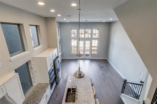 a view of staircase with lots of frames on wall and a window