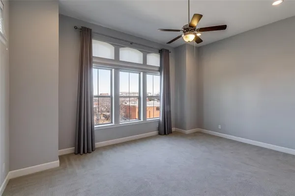a spacious bedroom with a bed and a chandelier