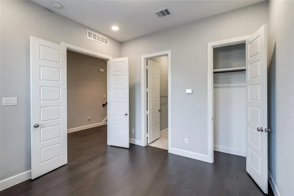 a bathroom with a granite countertop sink a toilet and a mirror