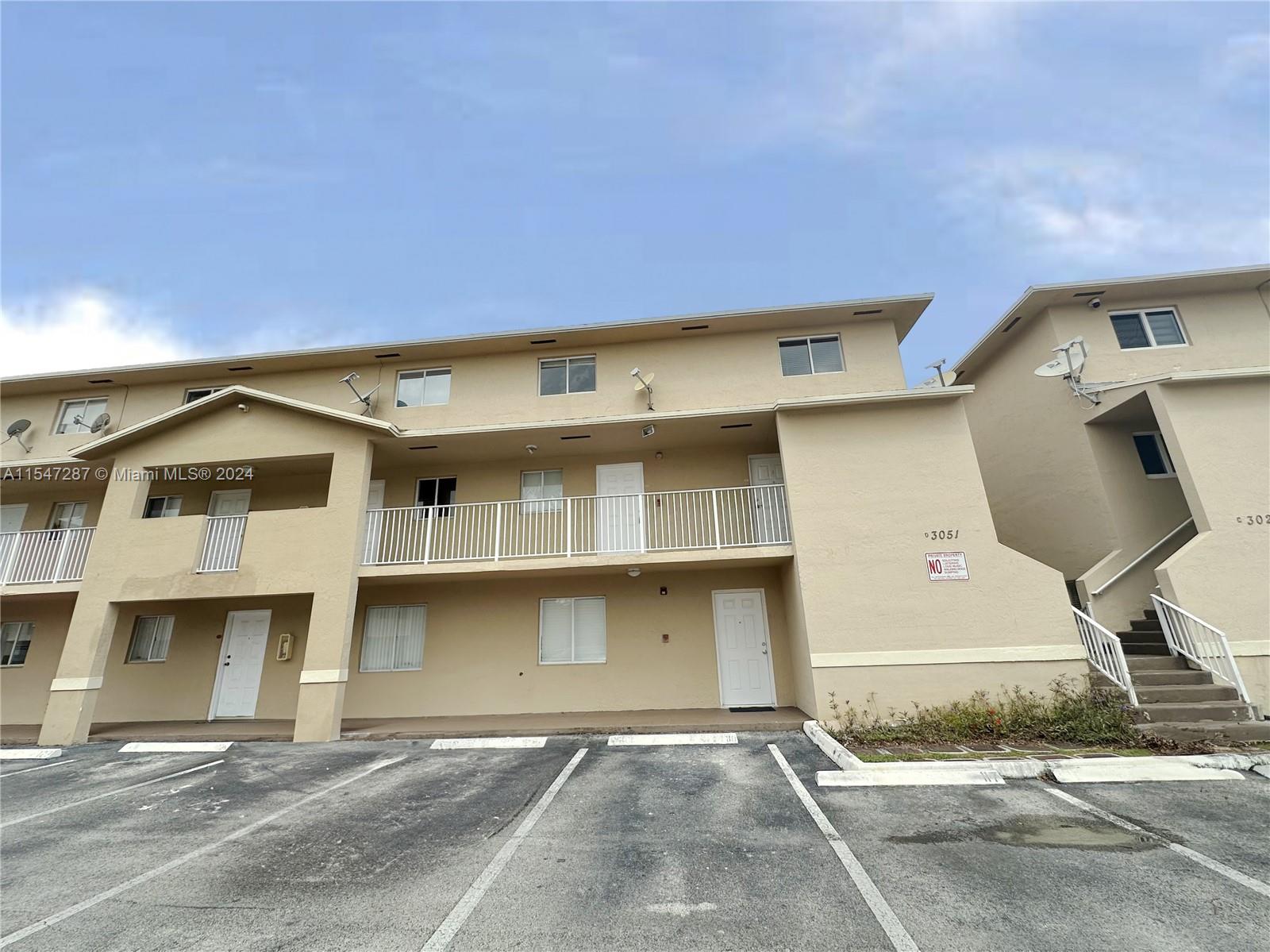 3051 West 76th Street, Unit D211 Hialeah, FL 33018 - Photo 1 of 22 a front view of a house with garage