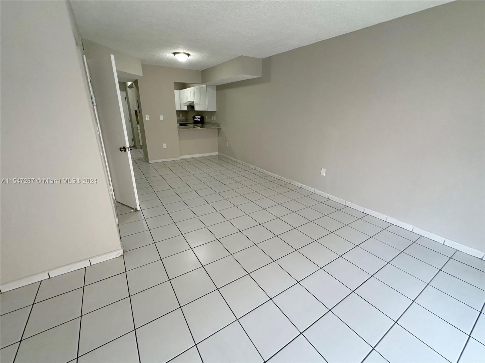 3051 West 76th Street, Unit D211 Hialeah, FL 33018 - Photo 12 of 22 a view of a livingroom and entryway