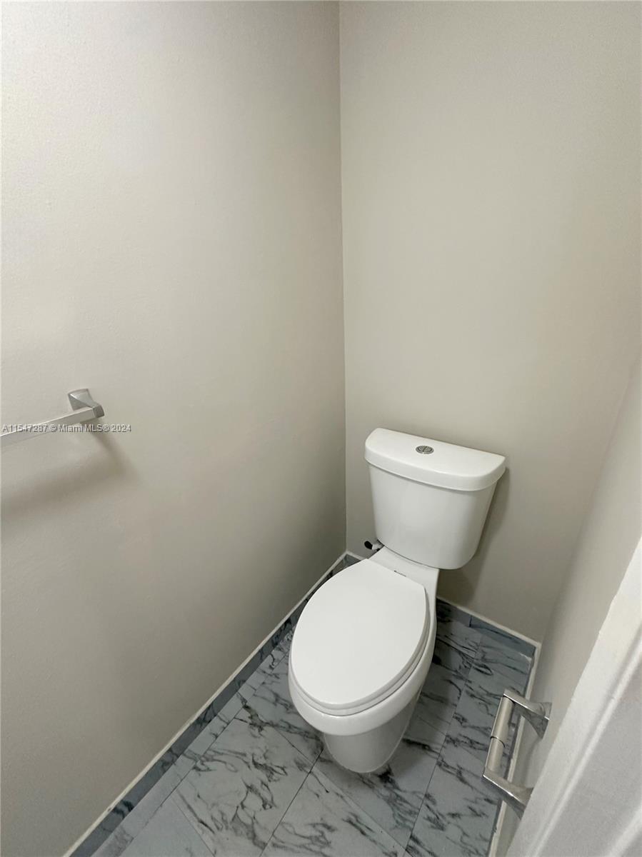 3051 West 76th Street, Unit D211 Hialeah, FL 33018 - Photo 14 of 22 a white toilet sitting next to a white sink