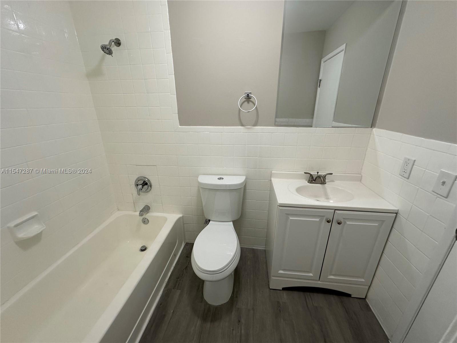 3051 West 76th Street, Unit D211 Hialeah, FL 33018 - Photo 18 of 22 a bathroom with a toilet sink and mirror