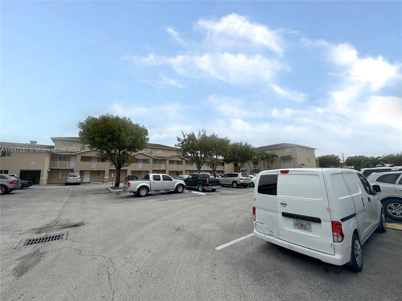3051 West 76th Street, Unit D211 Hialeah, FL 33018 - Photo 4 of 22 a view of a cars parking space in a parking lot