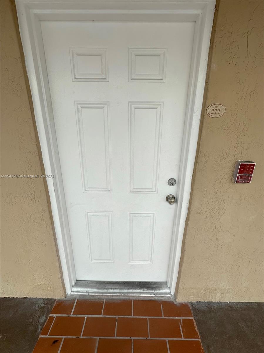 3051 West 76th Street, Unit D211 Hialeah, FL 33018 - Photo 5 of 22 a view of room with door