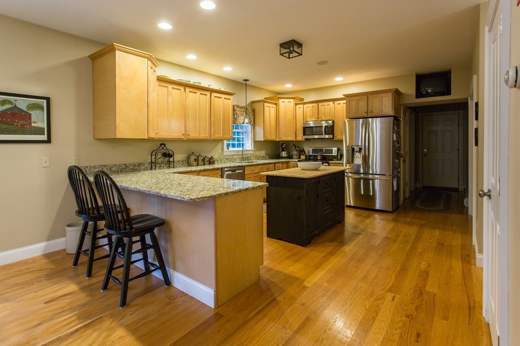 71 Ragged Hill Road West Brookfield, MA 01585 - Photo 3 of 19 a kitchen with stainless steel appliances granite countertop a table chairs stove and refrigerator