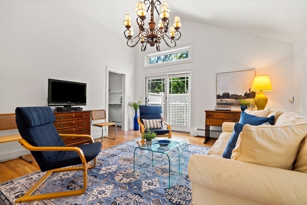 6 Dean Road Marblehead, MA 01945 - Photo 14 of 29 a living room with furniture a flat screen tv and a chandelier