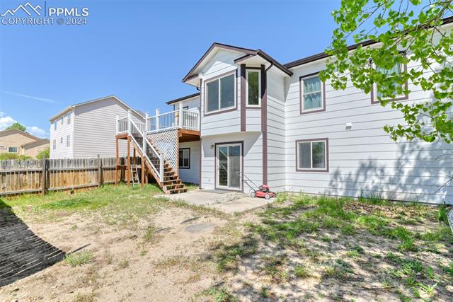 7863 Buschborn Road Peyton, CO 80831 - Photo 45 of 50 Rear view of property featuring a wooden deck
