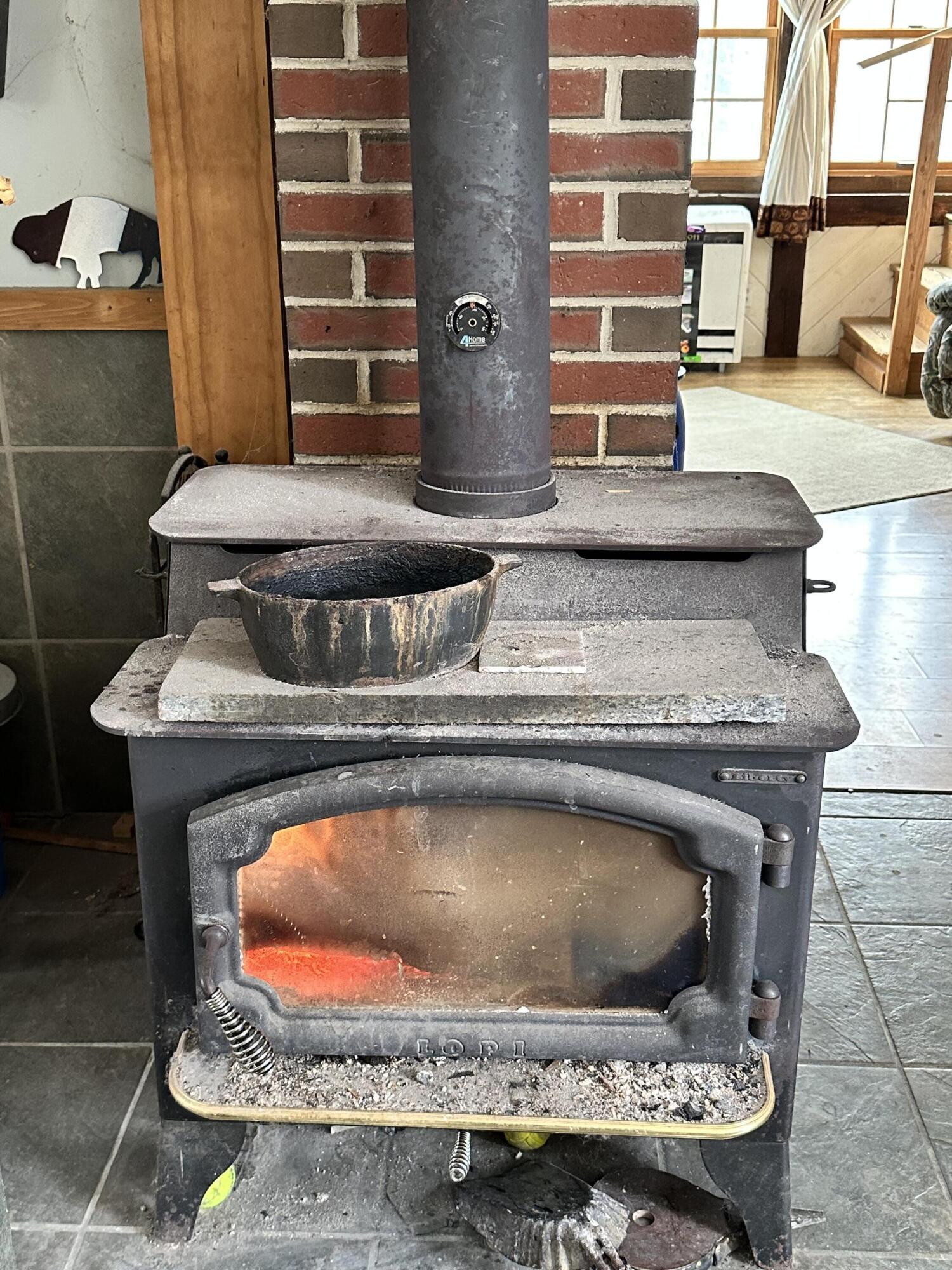 96 Webb Road Thorndike, ME 04986 - Photo 11 of 43 Wood burning stove in kitchen