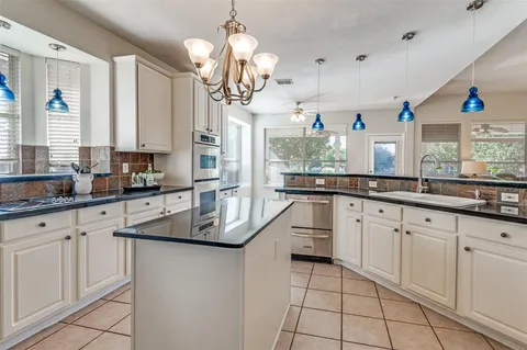a kitchen with cabinets a sink appliances and a counter top space