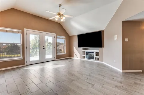 a view of livingroom with furniture flat screen tv and floor to ceiling window