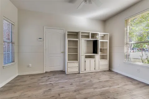 an empty room with a empty space and windows