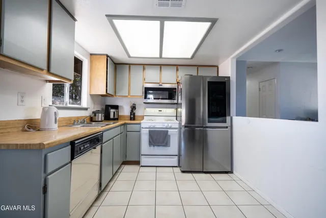 a kitchen with stainless steel appliances granite countertop a refrigerator sink and cabinets