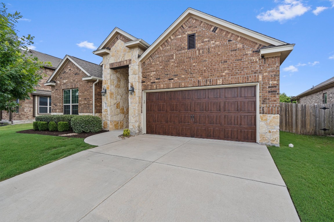a front view of a house with a yard and garage
