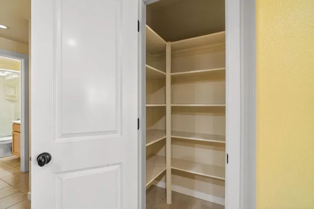 a living room with furniture a clock on wall and a window