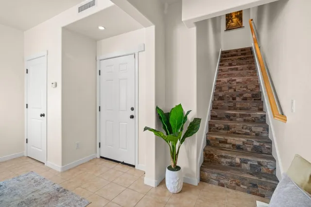 a view of a a dining room with furniture window and wooden floor