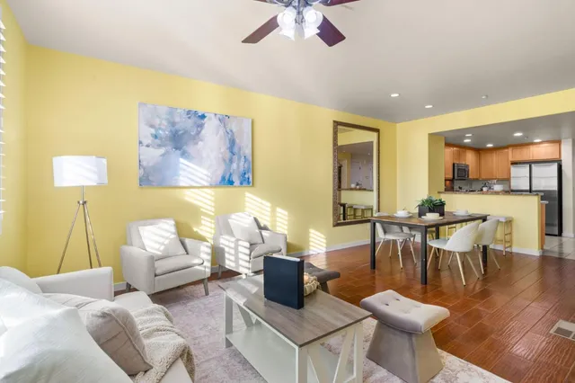 a kitchen with stainless steel appliances granite countertop a refrigerator a stove a sink and a microwave