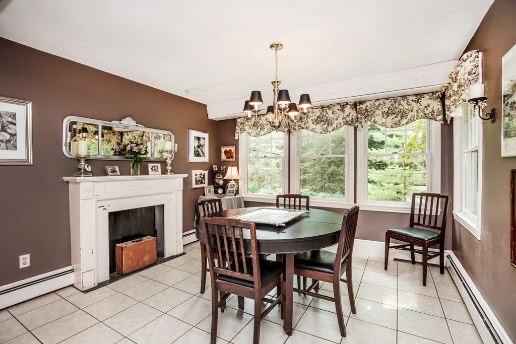 127 Haverhill Road Topsfield, MA 01983 - Photo 11 of 28 a dining room with furniture a fireplace and a chandelier