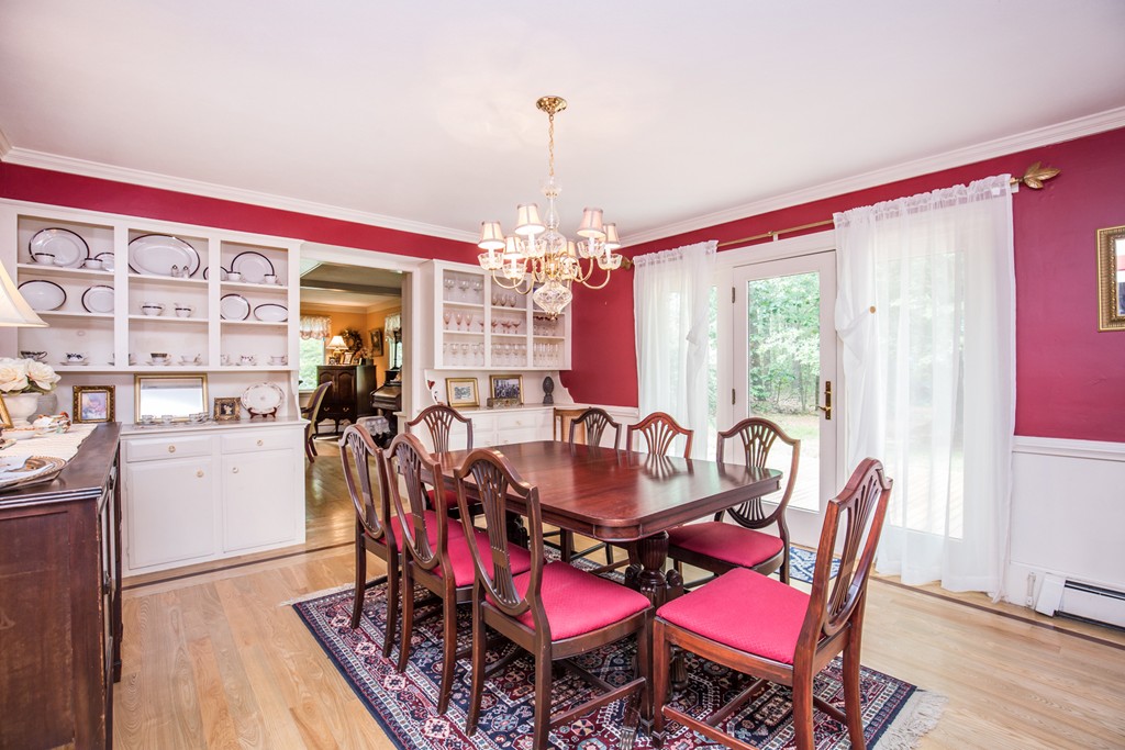 127 Haverhill Road Topsfield, MA 01983 - Photo 12 of 28 a dining room with furniture a chandelier and wooden floor
