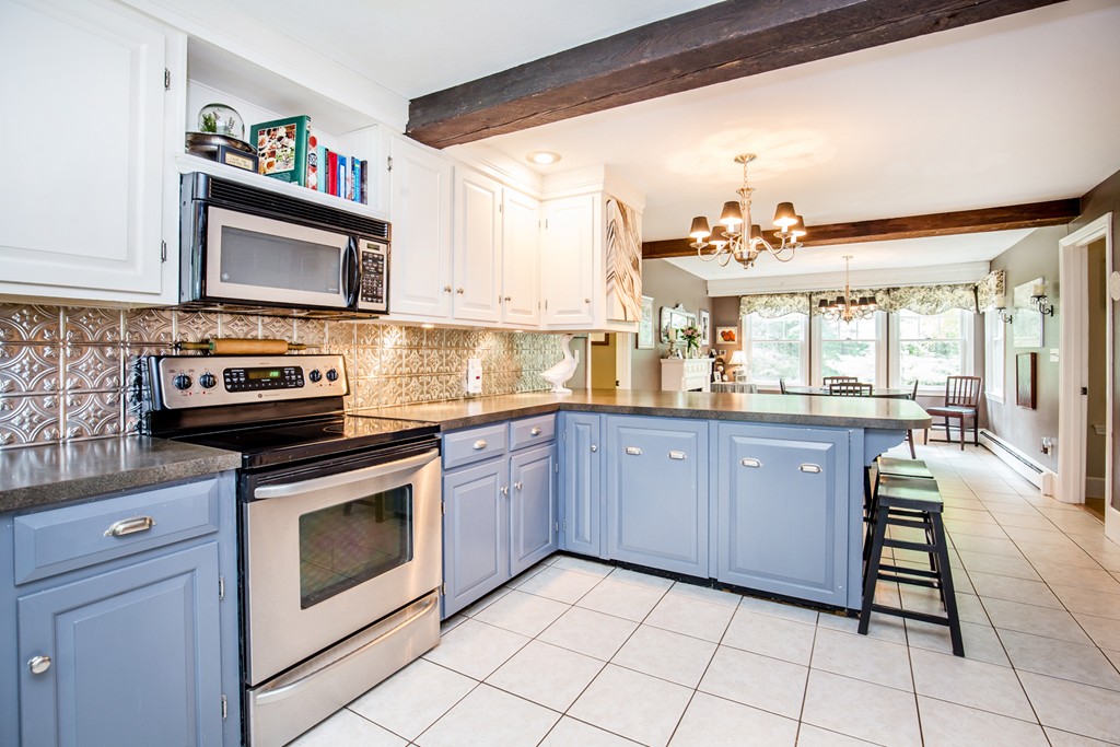 127 Haverhill Road Topsfield, MA 01983 - Photo 9 of 28 a kitchen with stainless steel appliances granite countertop a stove a sink and a microwave