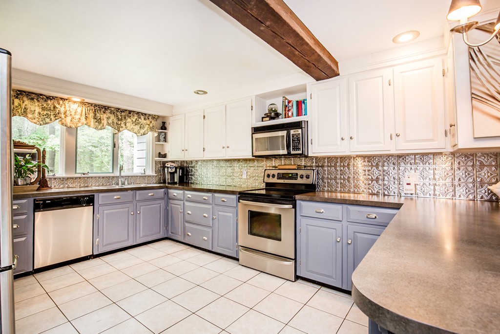 127 Haverhill Road Topsfield, MA 01983 - Photo 10 of 28 a kitchen with granite countertop cabinets stainless steel appliances a sink and a window
