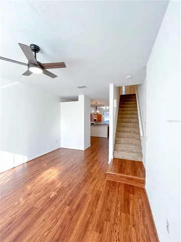 a view of empty room with wooden floor