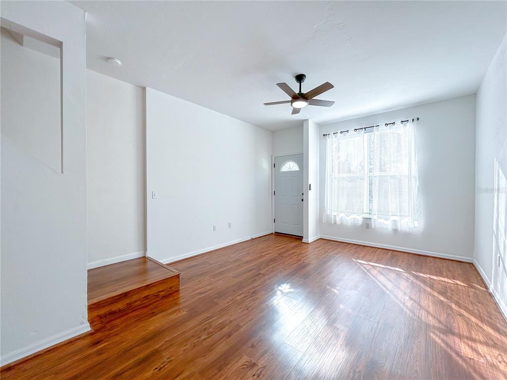 3575 Southwest 30th Way, Unit 119 Gainesville, FL 32608 - Photo 4 of 11 wooden floor in an empty room with a window