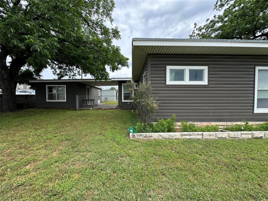 7350 Highway 67, Unit 377N Comanche, TX 76442 - Photo 5 of 13 a front view of a house with a garden