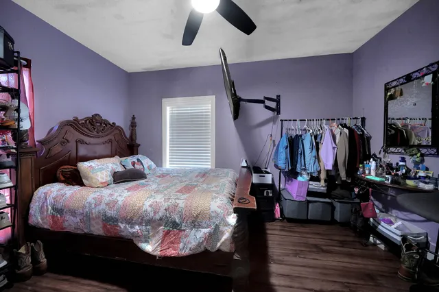 a bedroom with bed and wooden floor