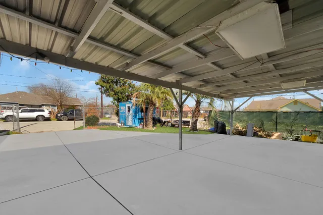 a view of house with yard and glass windows