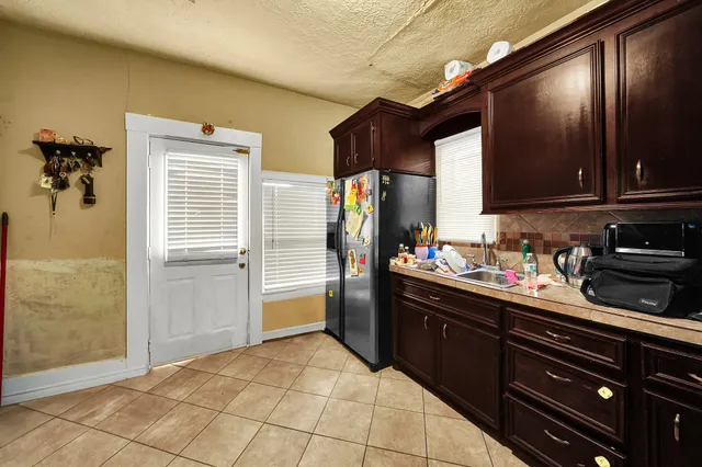 a kitchen with a sink a stove and cabinets