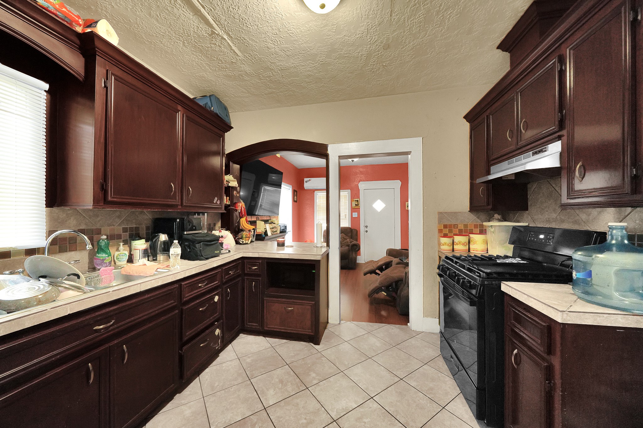 1414 Moody Street Houston, TX 77009 - Photo 19 of 27 a kitchen with a sink a stove and cabinets