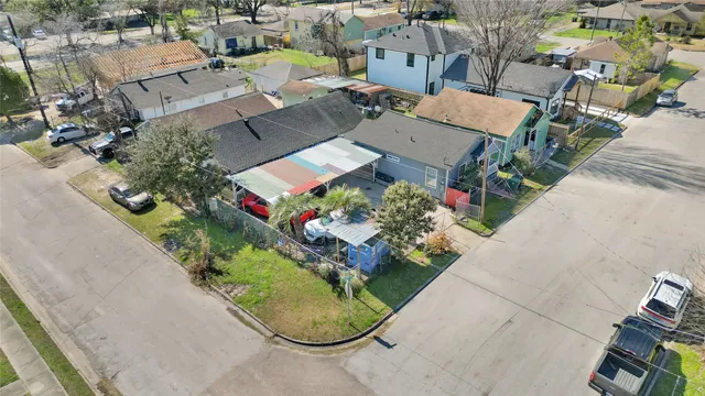 an aerial view of a house with a garden and mountain view in back