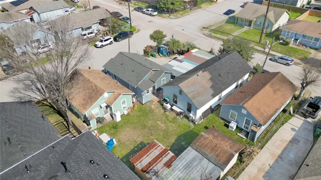 an aerial view of a house with a yard