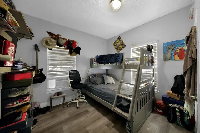 a bedroom with furniture and a flat screen tv