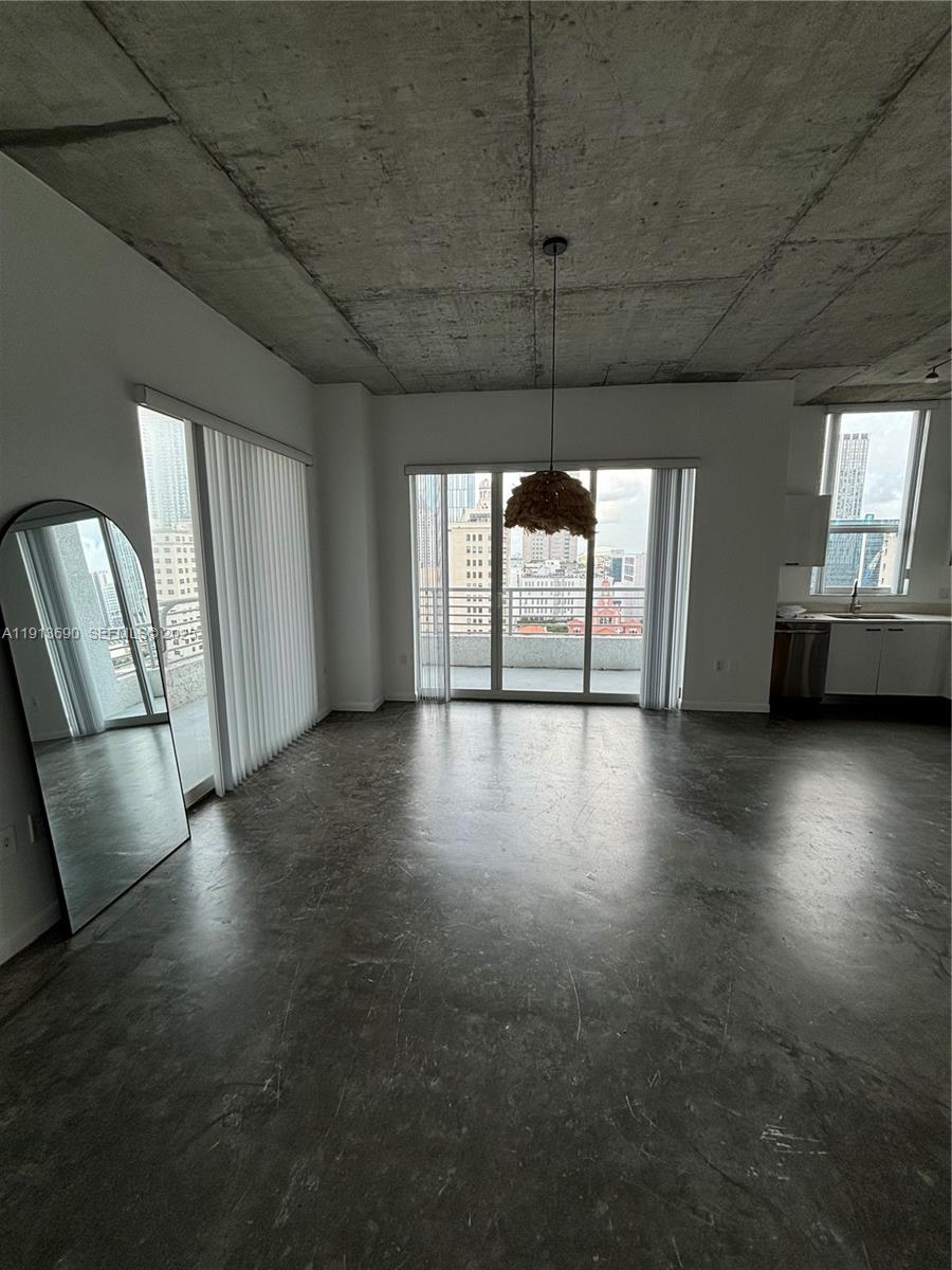 133 Northeast 2nd Avenue, Unit 1519 Miami, FL 33132 - Photo 11 of 41 an empty room with wooden floor and windows