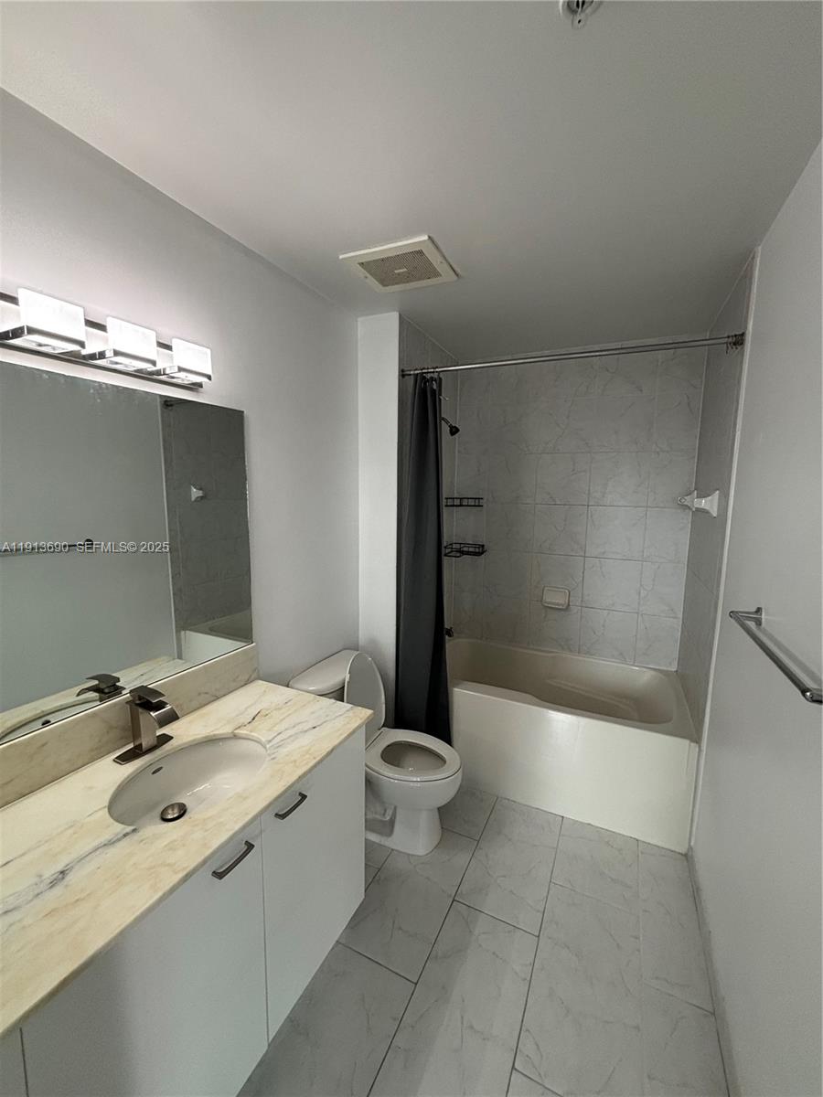 133 Northeast 2nd Avenue, Unit 1519 Miami, FL 33132 - Photo 17 of 41 a bathroom with a sink a toilet and shower