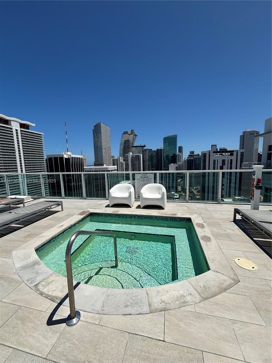 133 Northeast 2nd Avenue, Unit 1519 Miami, FL 33132 - Photo 24 of 41 a view of a swimming pool with a lounge chairs